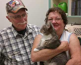 Tina Caines, with her husband and cat